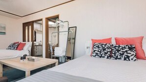 A hotel room with two beds, a small table, a mirror, and a desk with a chair. - Nippombashi Back Kuromon AFP Apartment (Osaka)