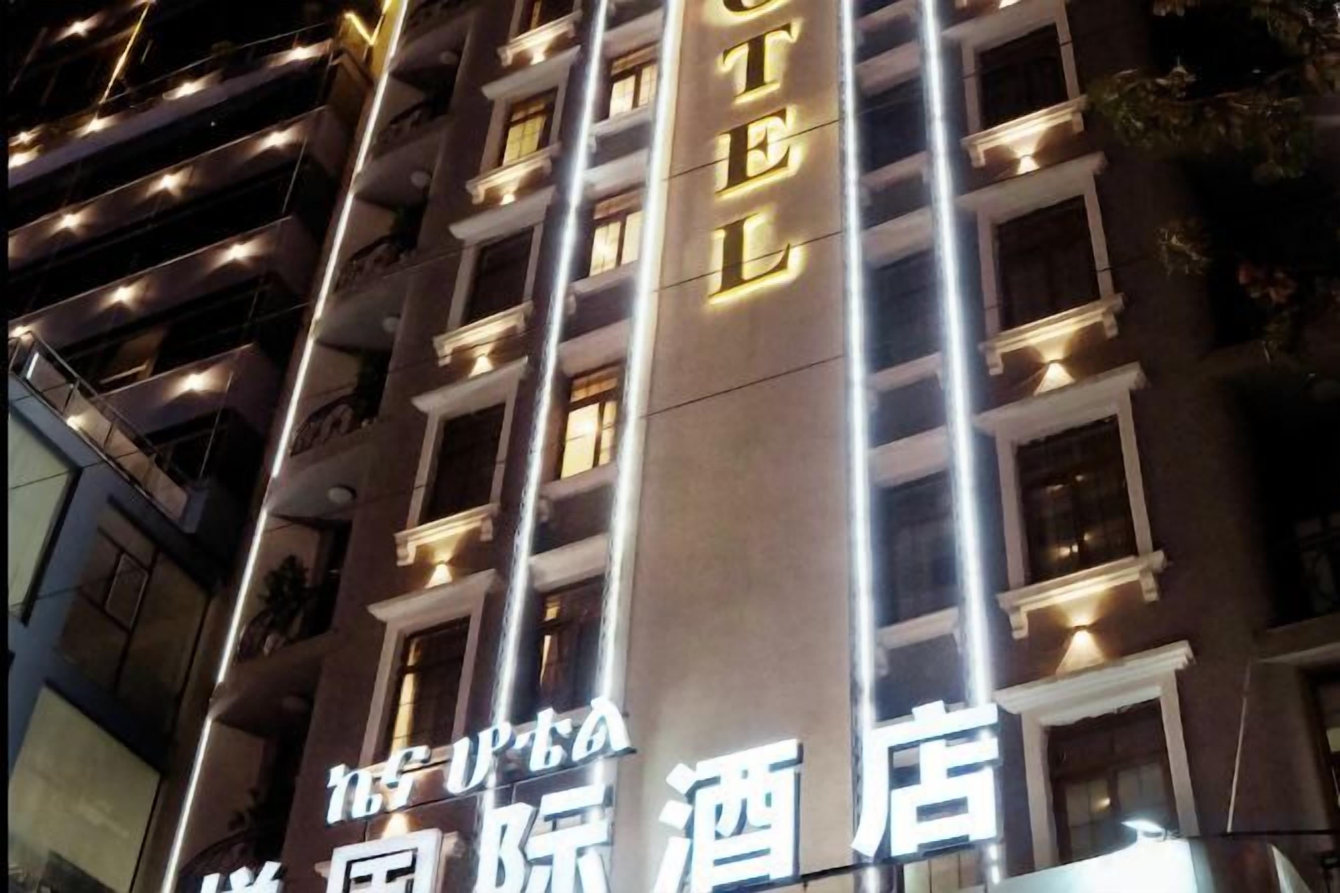 A hotel with illuminated signage, multiple floors, and a modern architectural design.