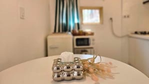 A table with a tissue holder and dried flowers.