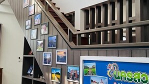 Una scala con ringhiere in legno e un muro decorato con quadri.