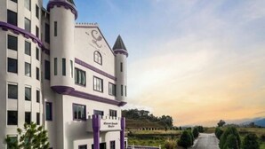 A castle-like building with multiple towers and a sign that reads "Castle Hotel." - Cameron Lavender Mansion (Brinchang)