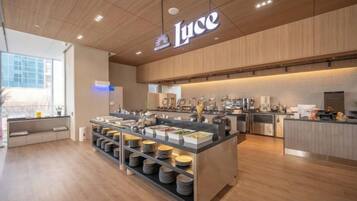 A modern cafe interior with a central island, seating area, and a visible counter.