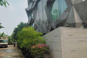A modern building with a geometric facade and a narrow street. - Dhaka Star Guest House (Dhaka)