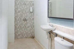 A bathroom with a shower, sink, and toilet. - KoolKost near Raya Canggu (Minimum Stay 5 Nights) (Bali)