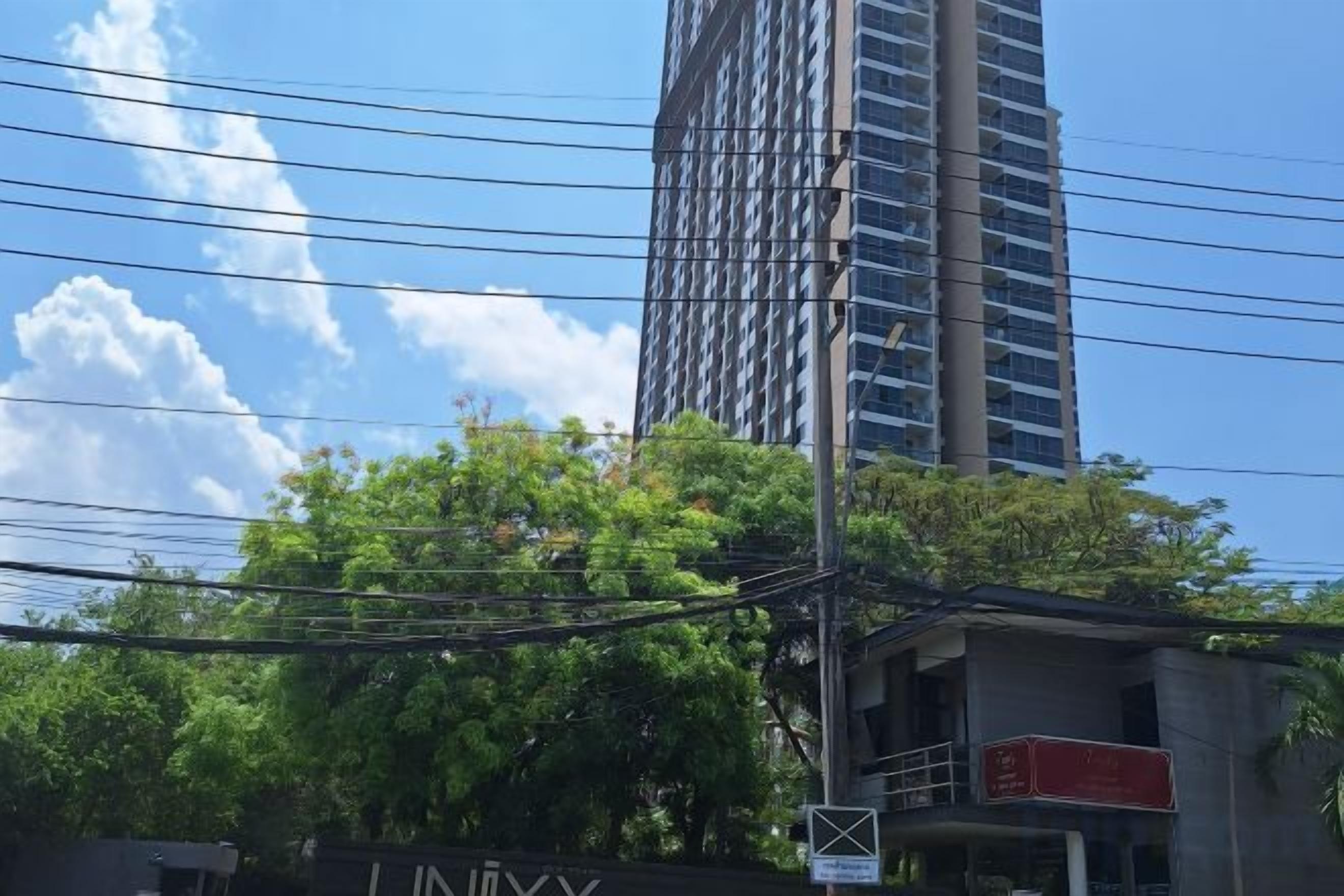 A building with a sign that reads 'LINUXY' and a tree in the foreground.
