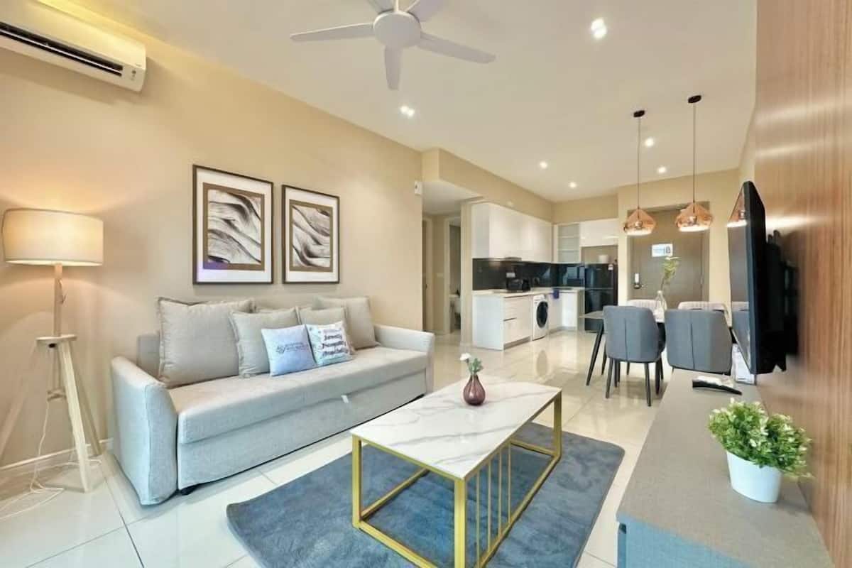 A modern living room with a sofa, coffee table, and artwork on the wall.