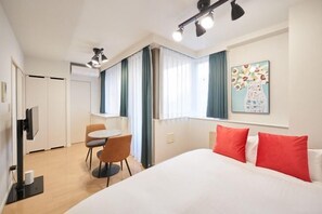 A hotel room with a bed, a desk, a chair, and a window with curtains. - Luce Takanawa (Tokyo)