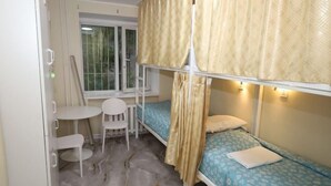 A bunk bed room with a window, a small table, and a chair. - UB Friends Hostel (Ulaanbaatar)