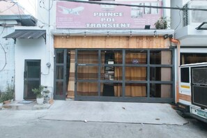 A storefront with a large sign for 'Prince Pol Transient' and a closed wooden shutter. - RedDoorz @ Prince Hotel near NAIA T1 (Pasay)