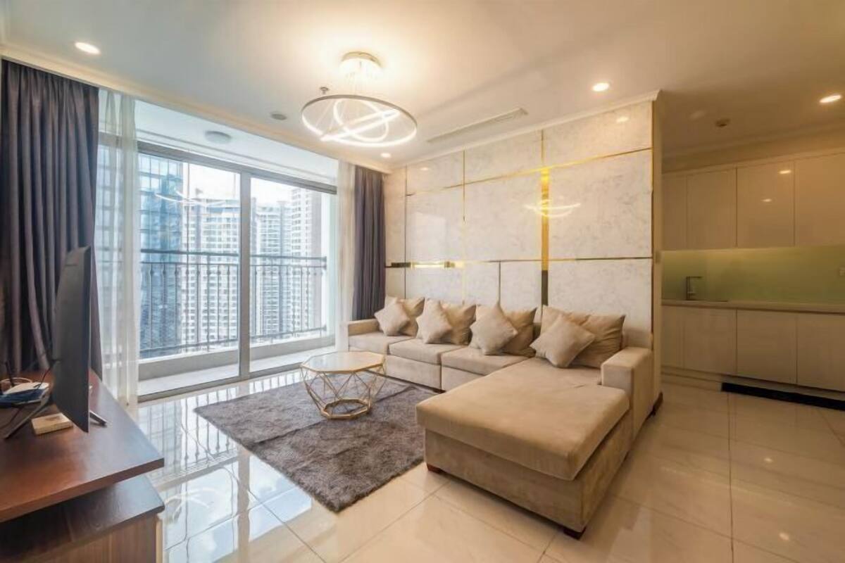A modern living room with a sofa, a coffee table, and a TV.