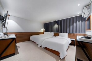 A modern hotel room with two beds, a desk, a chair, and a large window. - Jamsil Noblestay Hotel (Seoul)