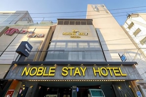 A hotel with a prominent sign for 'Noble Stay Hotel' and a visible entrance. - Jamsil Noblestay Hotel (Seoul)