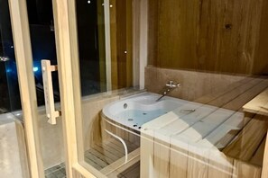 A glass-enclosed hot tub with a wooden deck, a wooden bench, and a wooden wall. - Al Dora All Inclusive Hotel (Hurghada)