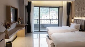 A hotel room with two beds, a large window with a view of buildings, a flat-screen TV, and a modern design. - Starry Sky Resort Hotel (Boten)