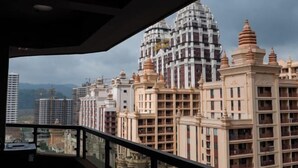 A view of a residential building with multiple floors and balconies, featuring a mix of modern and traditional architectural styles. - Starry Sky Resort Hotel (Boten)