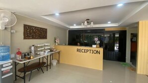 A reception area with a reception desk, a water dispenser, a fan, and a wall-mounted artwork. - Imboutique hotel Maesot (Mae Sot)
