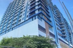A high-rise building with multiple balconies and a modern architectural design. - City Center Business Hotel(Manila Airport and PITX) (Paranaque)