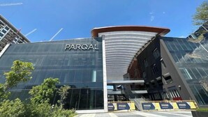 A modern building with the name 'PARQAL' prominently displayed on its facade.