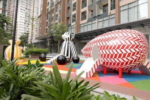 A colorful outdoor area with abstract sculptures and a building in the background. - A Quiet Stay - Service Apartment, Vinhome Ocean Park, Ha Noi (Hanoi)