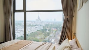 A room with a large window, a bed, and curtains. - A Quiet Stay - Service Apartment, Vinhome Ocean Park, Ha Noi (Hanoi)
