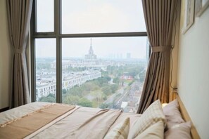 A room with a large window, a bed, and curtains. - A Quiet Stay (Hanoi)