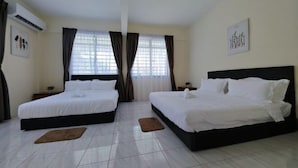 A hotel room with two beds, a large window with curtains, a wall-mounted air conditioner, and a framed picture. - Riverside Lot No.1 Homestay at Kota Kinabalu (Putatan)