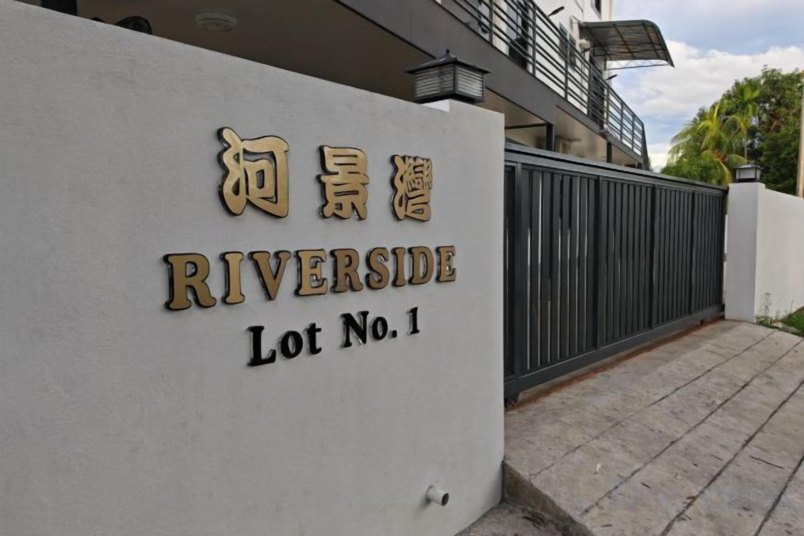 A gated entrance with a sign indicating 'RIVERSIDE Lot No. 1'.