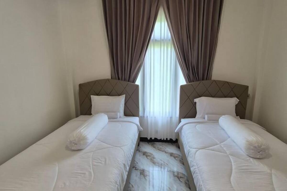 A double room with two beds, a window with curtains, and a marble floor.