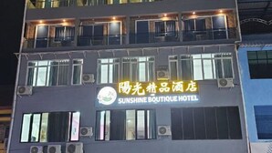 Ein mehrstöckiges Gebäude mit einem Schild für das Sunshine Boutique Hotel.