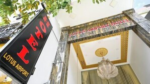 The exterior of the Lotus Airport Hotel with a sign indicating its name. - Lotus Airport Hotel Saigon (Ho Chi Minh City)