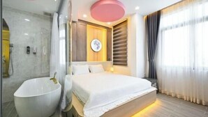 A modern hotel room with a large bed, a bathtub, and a shower. - Lotus Airport Hotel Saigon (Ho Chi Minh City)