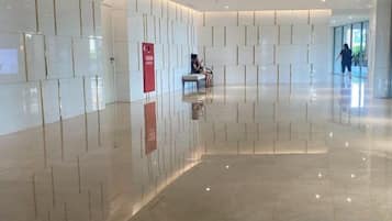A spacious lobby with a polished floor and a seating area.