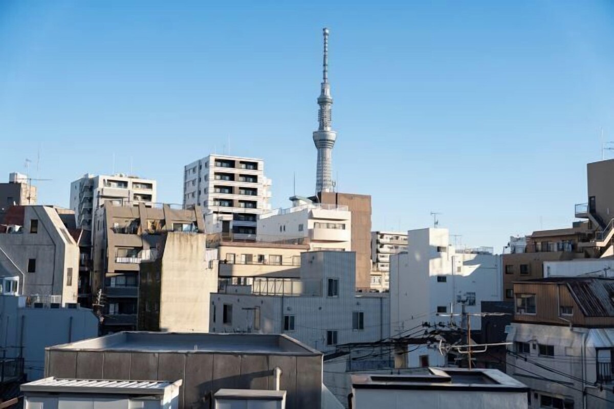 A cityscape with a prominent tower and various buildings.