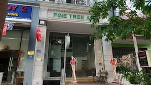 A hotel entrance with a sign reading "Pine Tree A". - PINE TREE APT (Ho Chi Minh City)