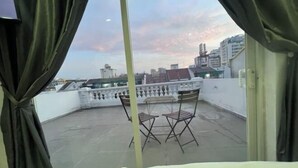 A room with a view of a cityscape through a window with curtains. - PINE TREE APT (Ho Chi Minh City)