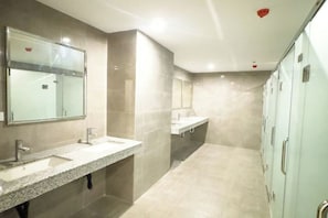 A modern bathroom with two sinks, a large mirror, and a shower area. - Luxury Penthouse hotel near City of Dreams Solaire Okada NAIA MOA- 1812 (Paranaque)