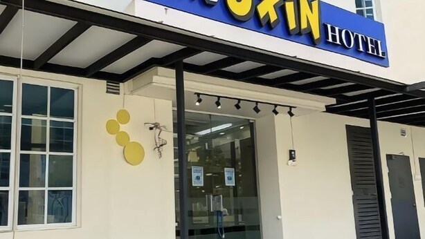 A hotel entrance with a sign reading "Okin Hotel."