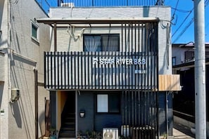 A modern building with a sign reading "STAR RIVER B&B". - Seishukugawa (Osaka)