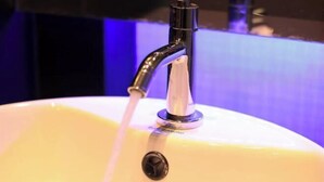 A bathroom sink with running water, a faucet, and a soap dispenser. - Windmill Place Khaoyai (Pak Chong)