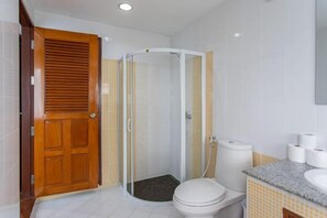 A bathroom with a shower, toilet, and sink. - tropical private pool villa (Bangkok)