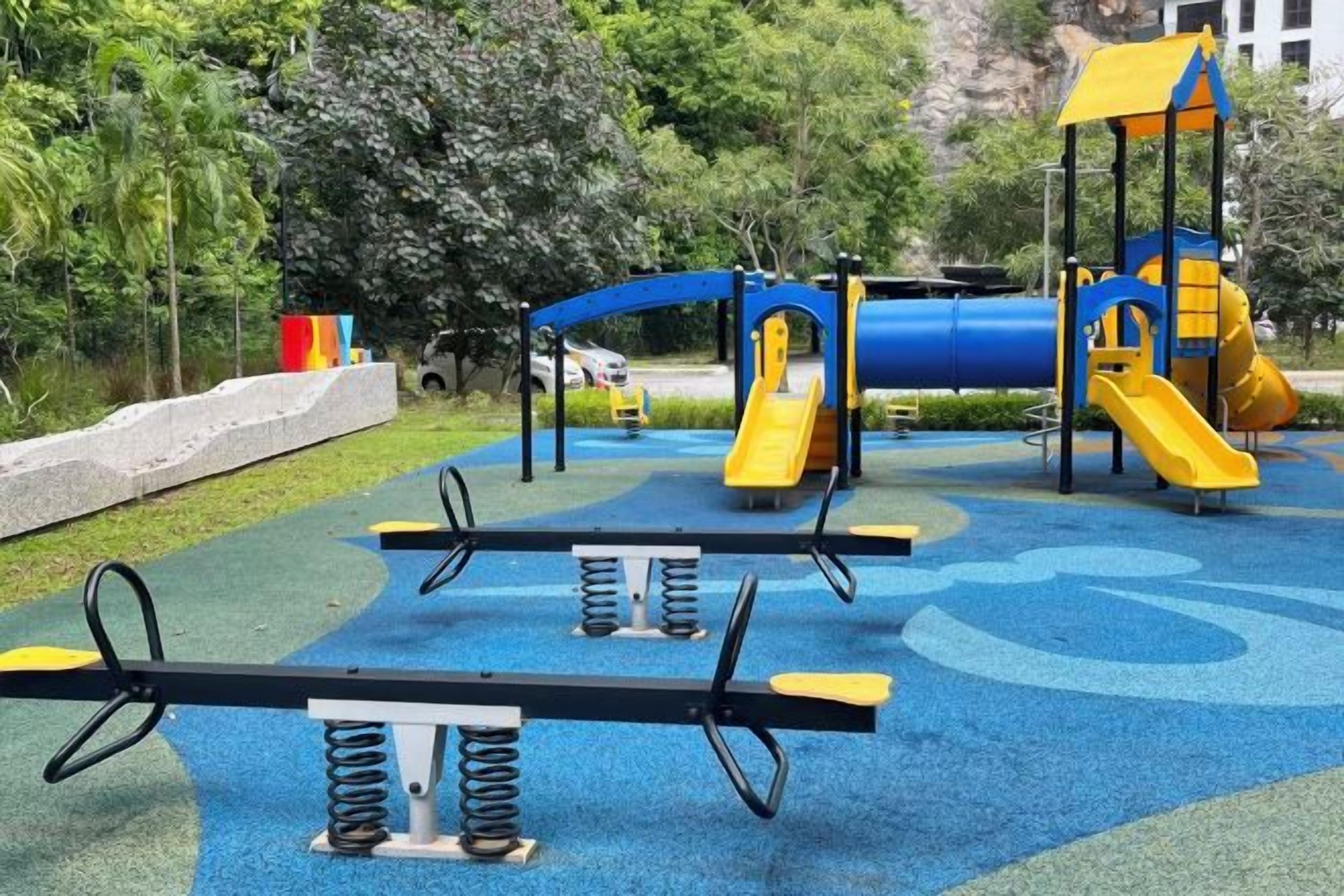 A playground with exercise equipment and a slide.