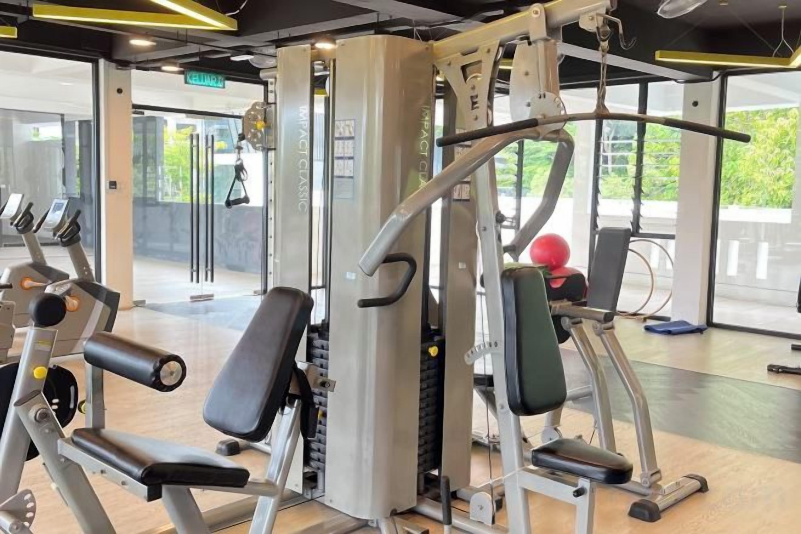 A gym with exercise equipment, including a squat rack and weight machines.