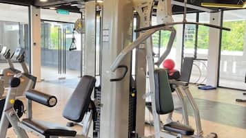 A gym with exercise equipment, including a squat rack and weight machines.