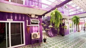 A purple interior with a patterned floor, a fan, and potted plants. - 5 Diamond (Bangkok)