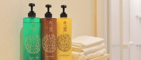 Three bottles of body care products on a shelf.