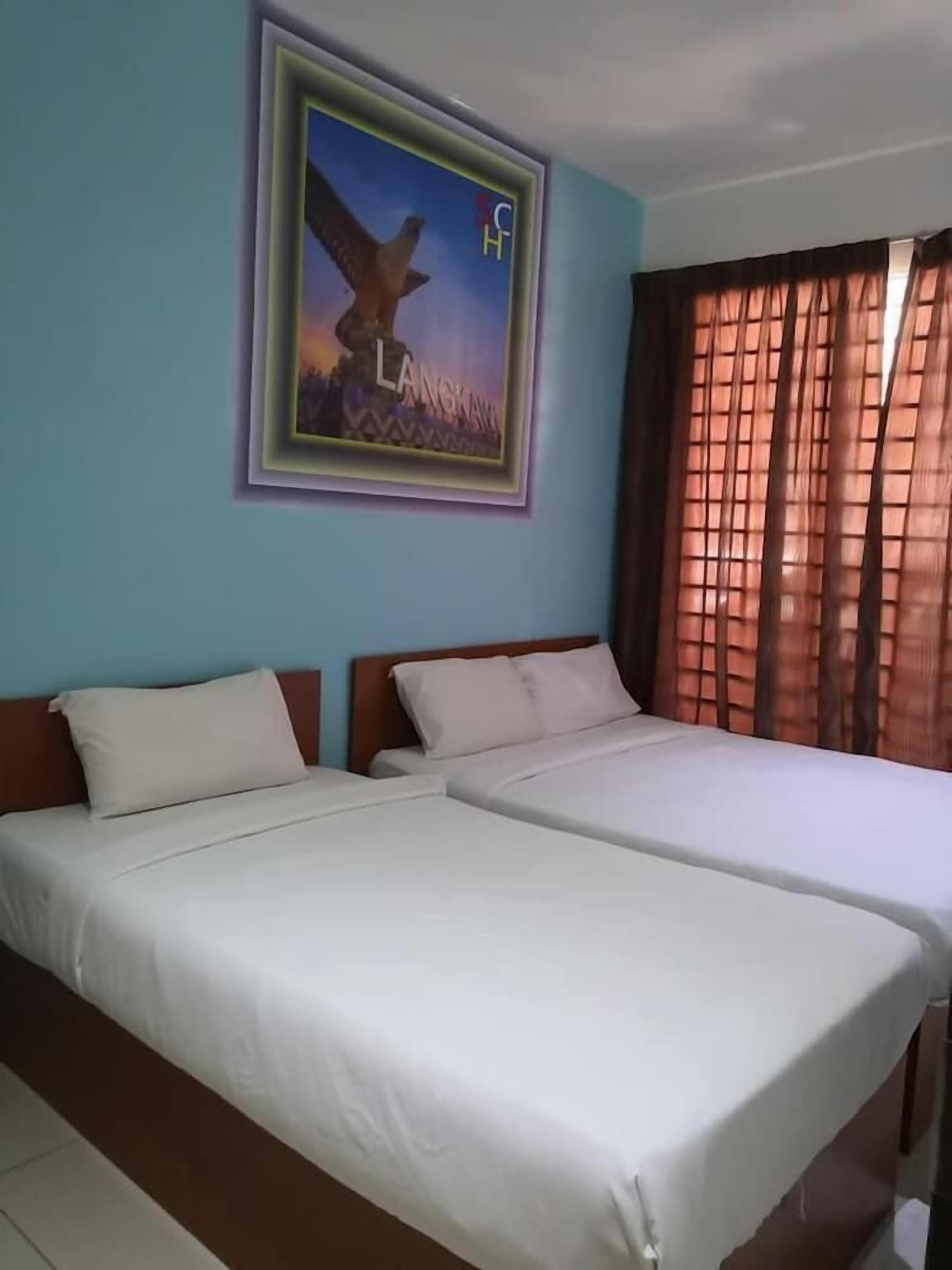 A hotel room with two beds, a framed picture on the wall, and a window with curtains.