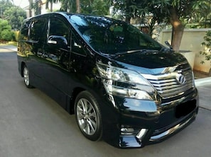 A black minivan parked on a street. - Swing & Pillows @ KL Pekeliling (Kuala Lumpur)