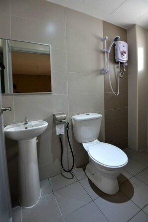 A bathroom with a sink, toilet, and a hand dryer. - Swing & Pillows @ KL Pekeliling (Kuala Lumpur)