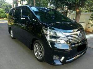 A black minivan parked on a street. - Swing & Pillows @ KL Pekeliling (Kuala Lumpur)