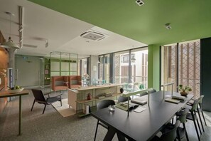 A modern office space with a long table, chairs, and a glass partition. - Express by M Village Global City, a brand of Modern Village Lifestyle (Ho Chi Minh City)